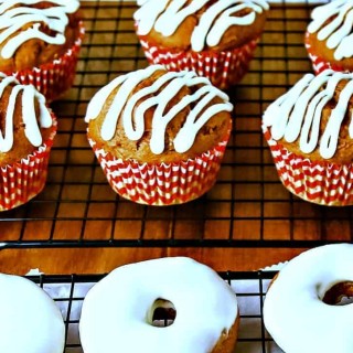 A table topped with pumpkin spice muffins and donuts