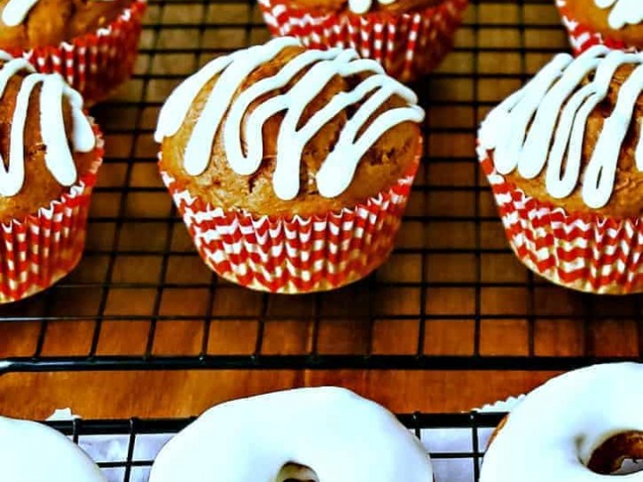 A table topped with pumpkin spice muffins and donuts