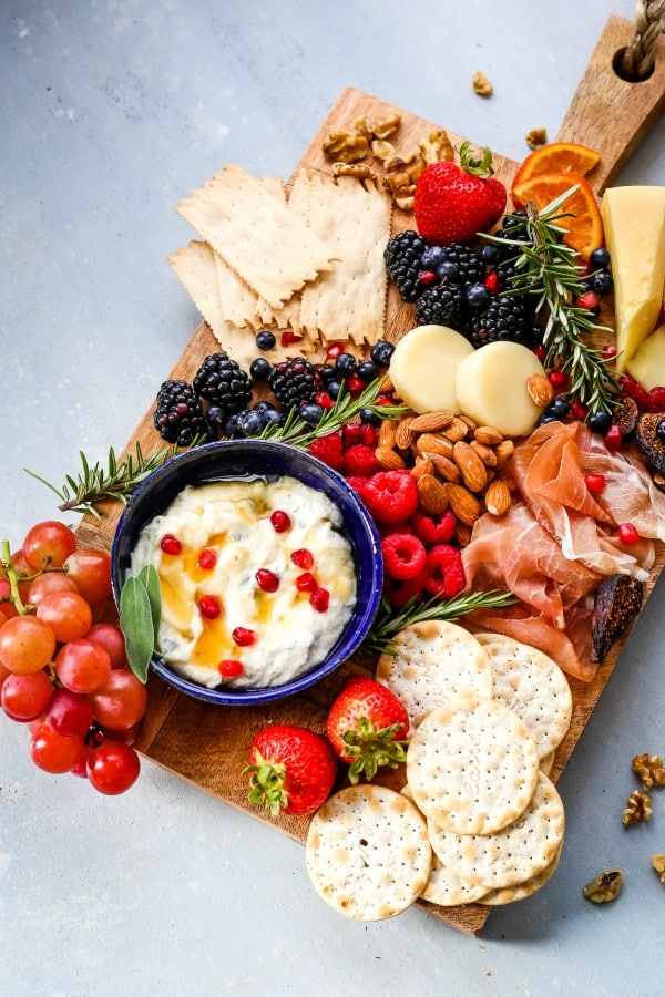 A bunch of food on a cheeseboard