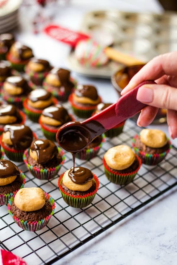 Drizzling chocolate on buckeye brownie bites