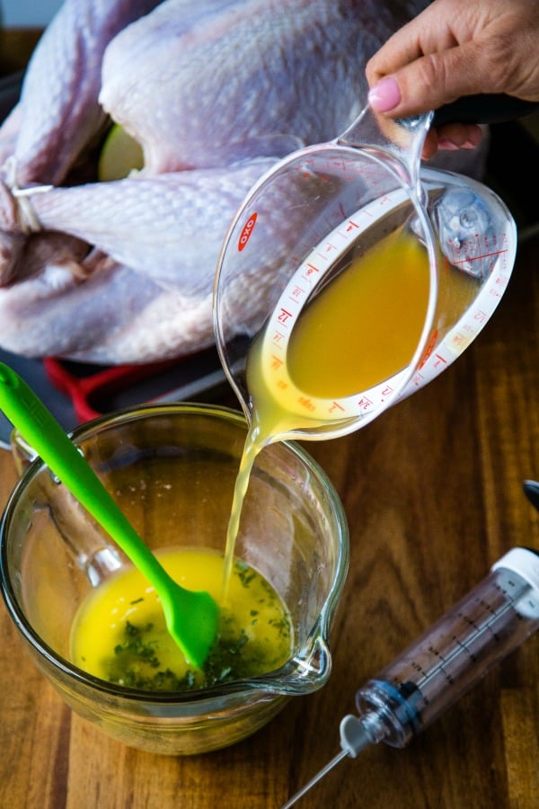 pouring apple cider into a marinade