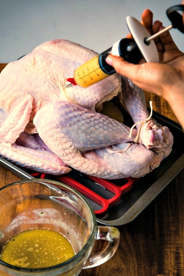 Injecting a raw turkey with apple cider
