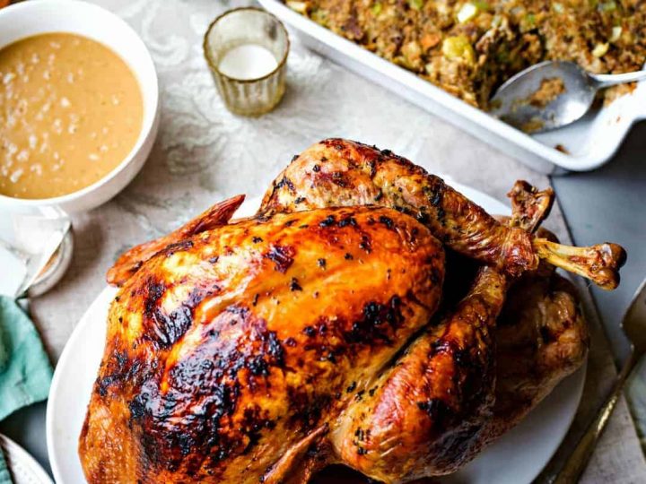 A roasted turkey on a platter on a table