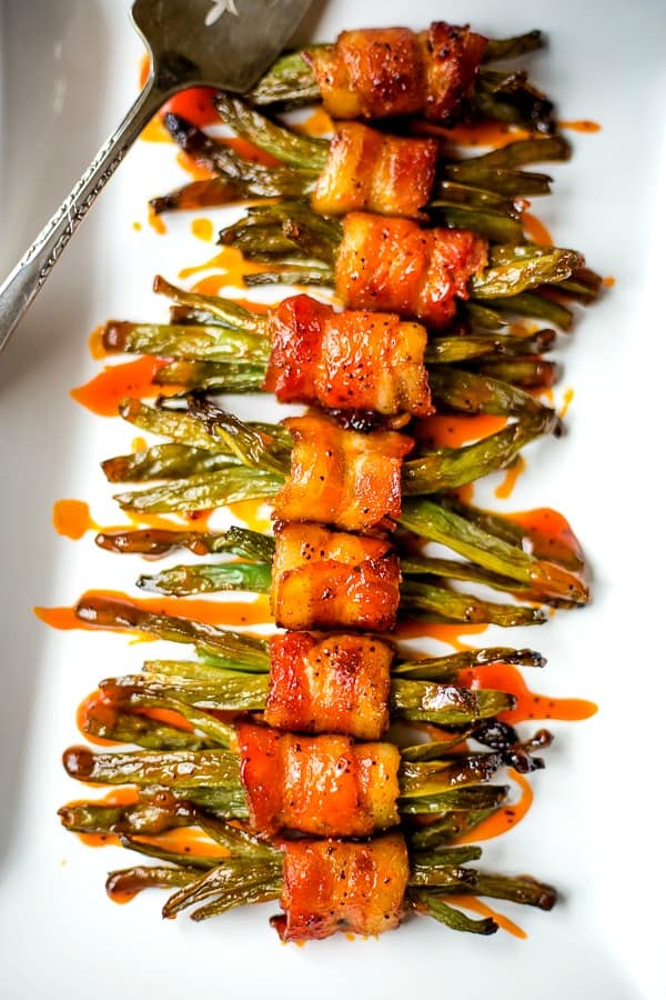 Bacon Wrapped Green Bean Bundles on white serving tray