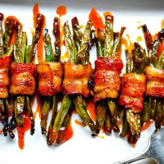 Bacon Wrapped Green Bean Bundles on white serving tray