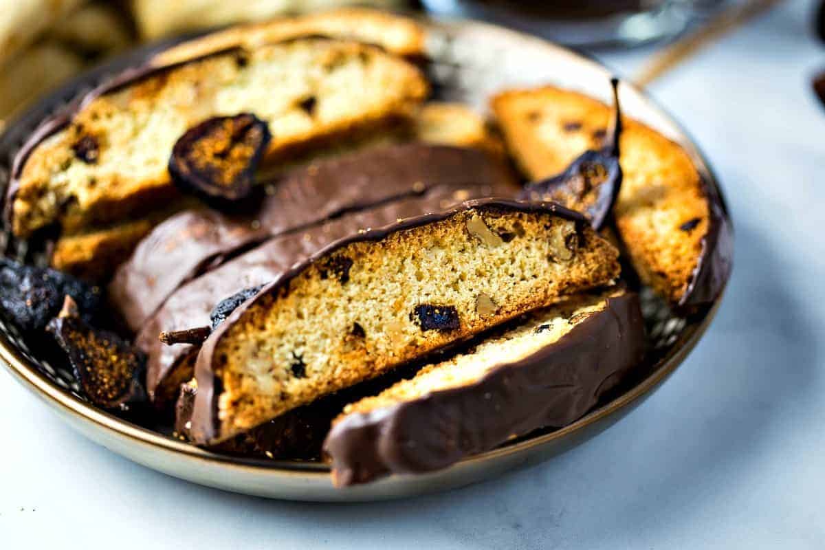 Fig and Walnut Biscotti with Dark Chocolate on gold plate