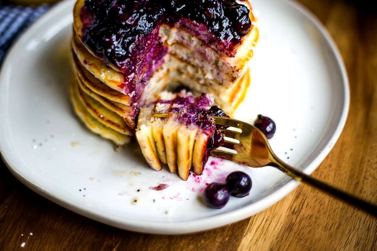 Lemon Poppy Seed Pancakes with Blueberry Compote on a fork