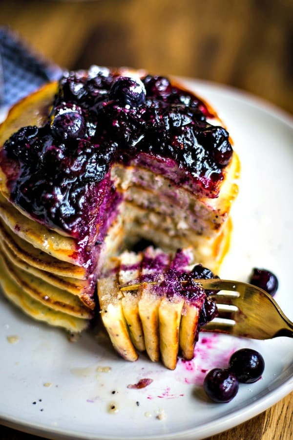 Lemon Poppy Seed Pancakes with blueberry compote on a fork