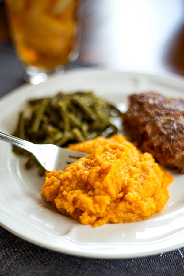 Mashed Sweet Potatoes on dinner plate with green beans and meatloaf