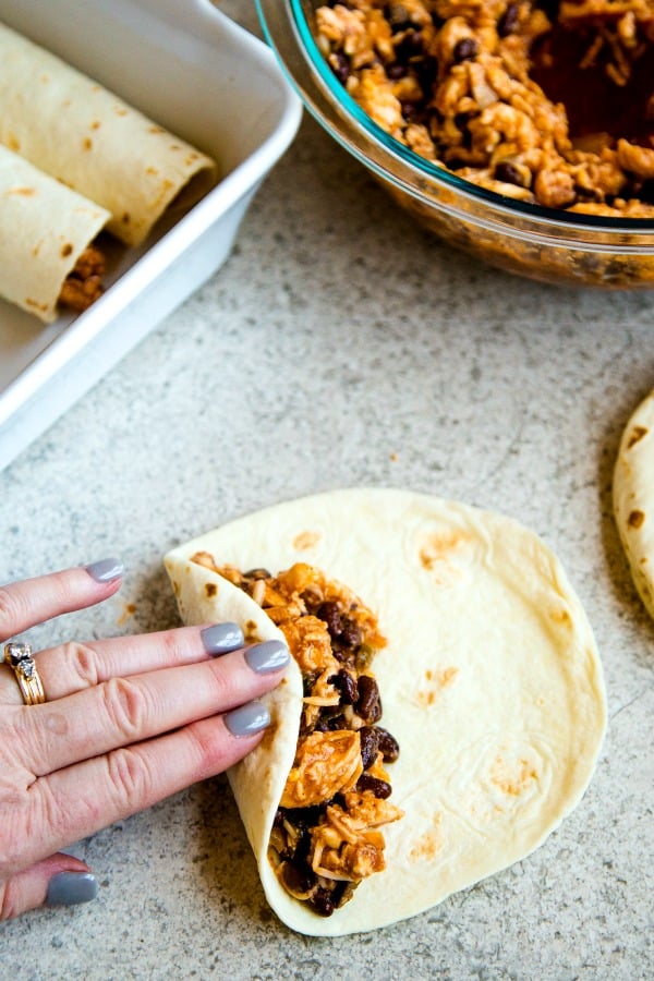 Chicken Black Bean Enchiladas - rolling enchiladas