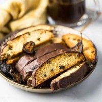 Fig Walnut Chocolate Dipped Biscotti on top of coffee cup