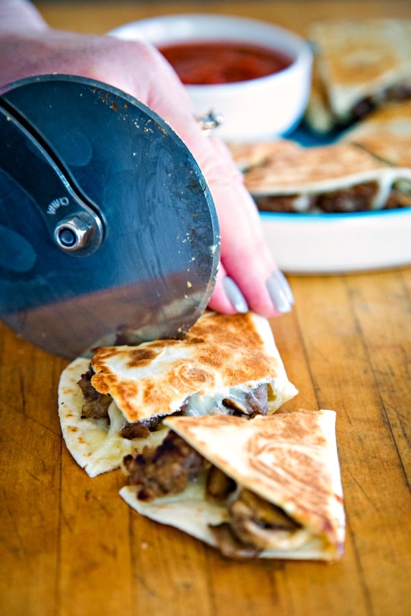 Cutting pizza-dillas with pizza cutter