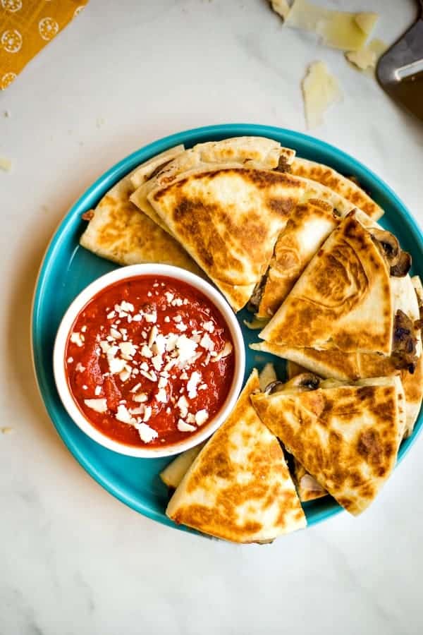 Sausage Mushroom Pizza-Dillas on blue plate with marinara sauce