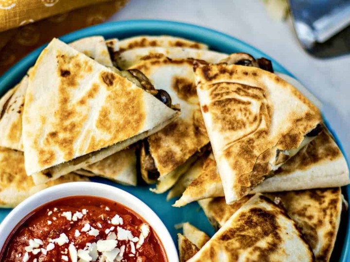 Sausage Mushroom Pizza-Dillas on blue plate with marinara sauce