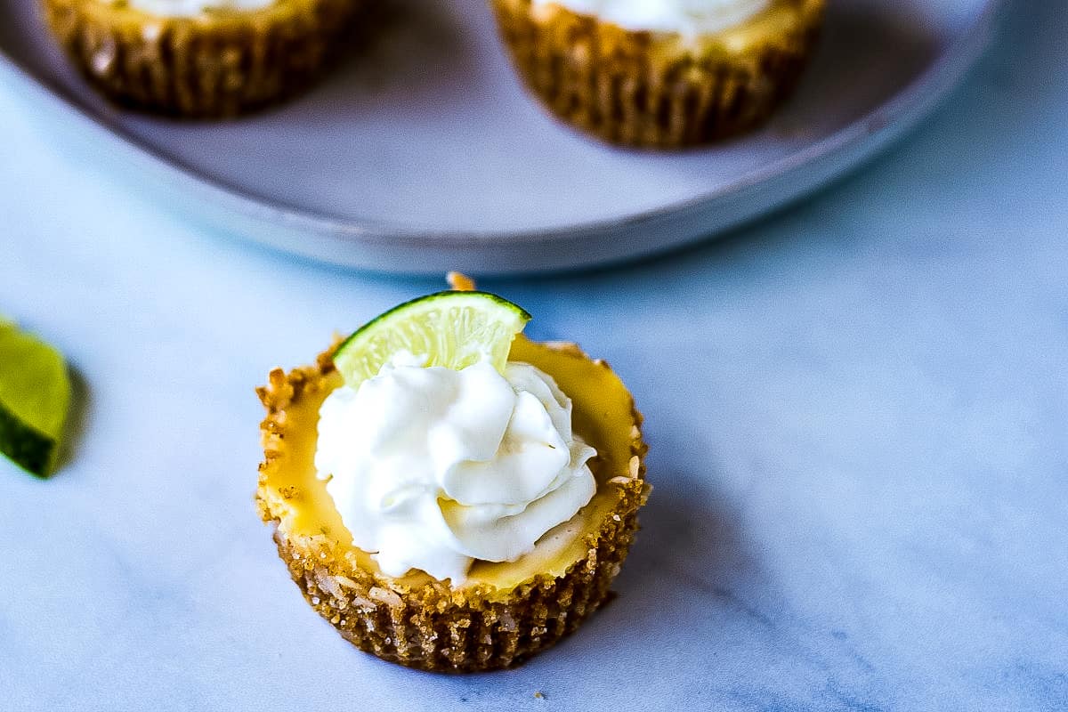 Mini Coconut Key Lime pie with whipped cream and lime slice