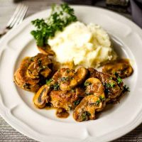 Pork Medallions in Mushroom Marsala Sauce with mashed potatoes on a plate