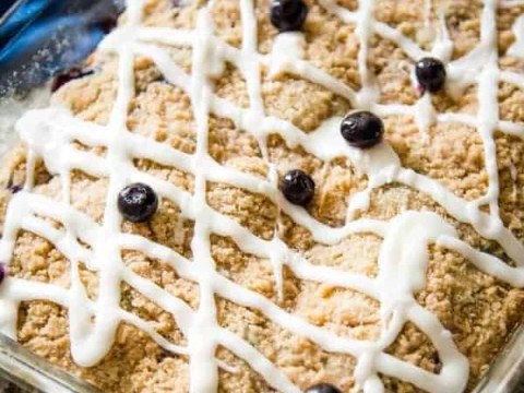 blueberry crumb cake with lemon glaze with fresh blueberry garnish