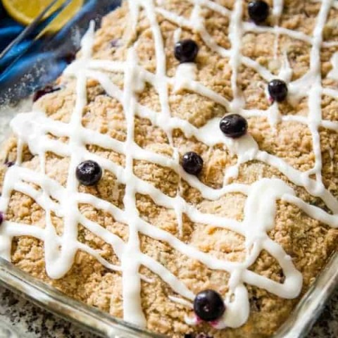 blueberry crumb cake with lemon glaze with fresh blueberry garnish