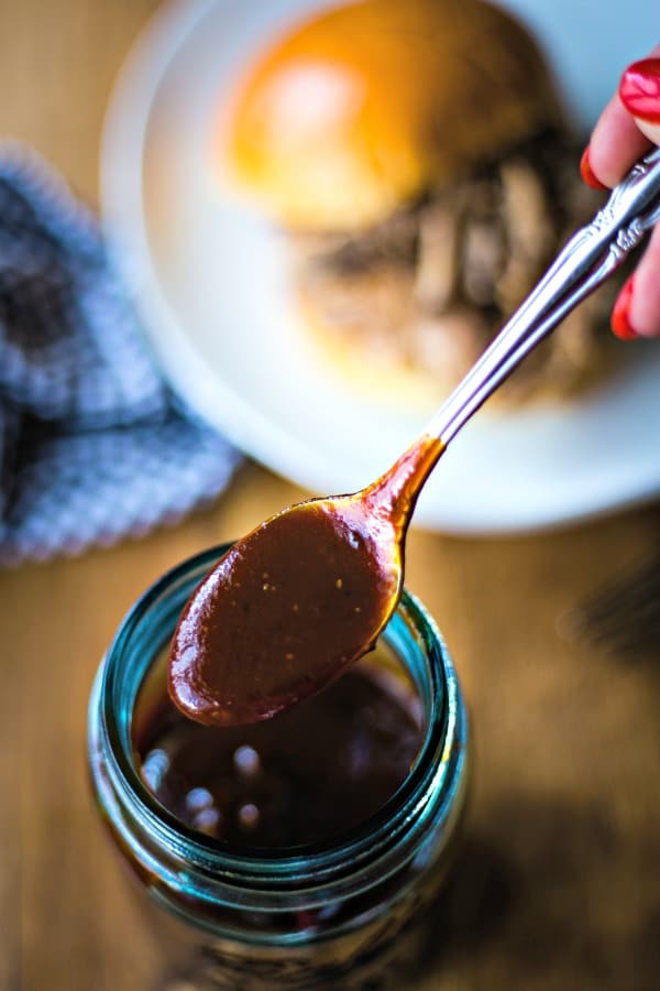 A jar of barbecue sauce, with a spoon