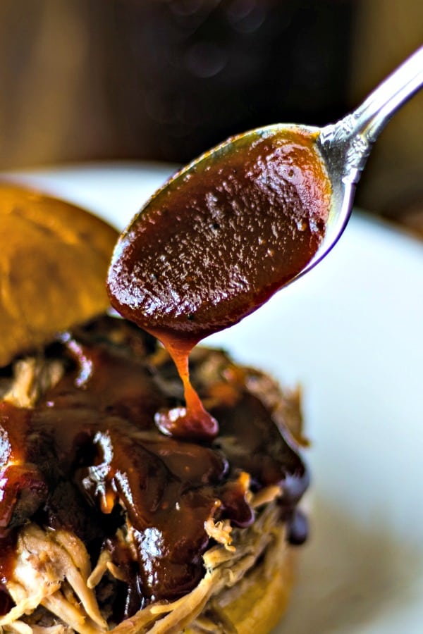 A close up of A jar of barbecue sauce, with a spoon