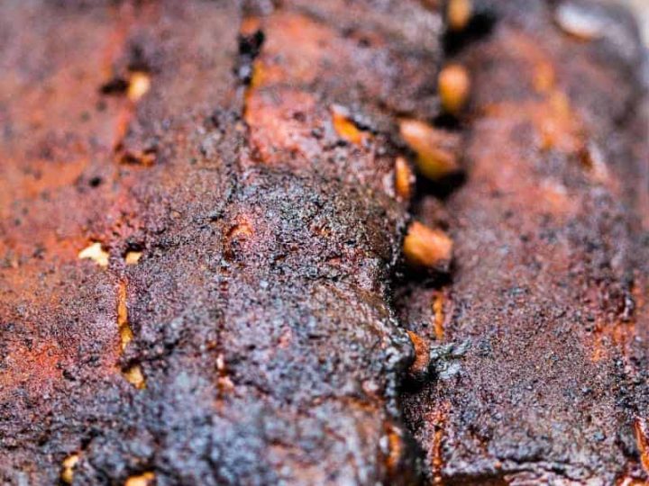 two racks of smoked baby back ribs in an aluminum pan