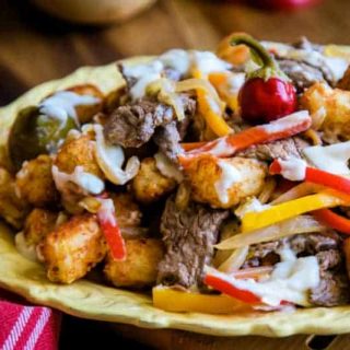 A plate of food on a table, with Beef and peppers