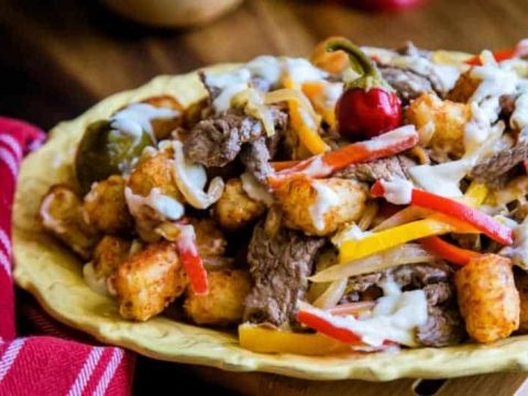 A plate of food on a table, with Beef and peppers