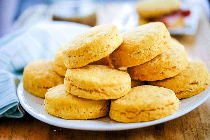 a stack of Buttery Sweet Potato Biscuits on a white plate