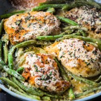 chickenn dijon simmering with green beans in a fry pan