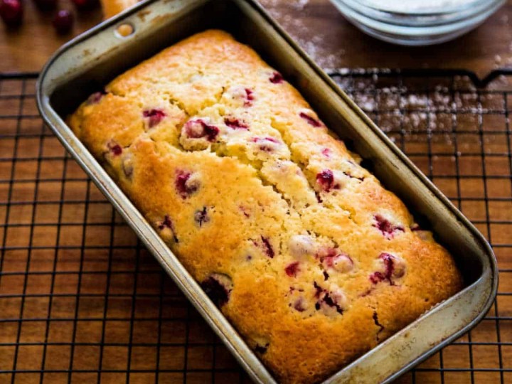 a quick loaf cooling in a loaf pan on a cooling rack