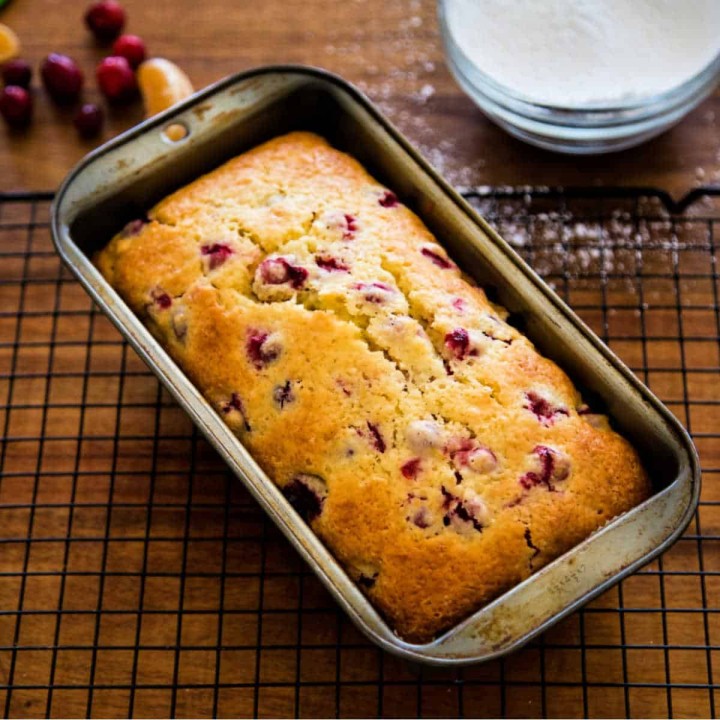 a quick loaf cooling in a loaf pan on a cooling rack