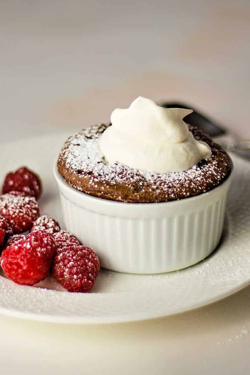 Chocolate Soufflé with whipped cream and raspberries