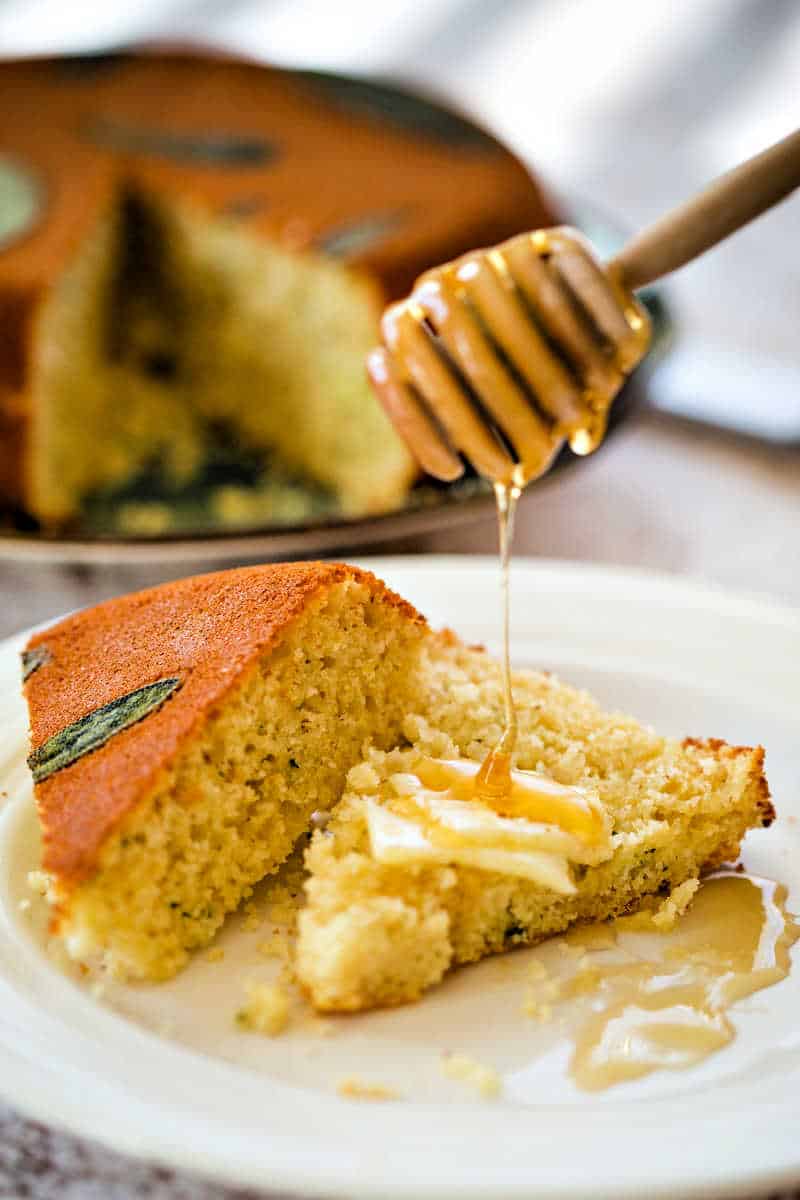 honey being drizzled onto Honey Cornbread with Sage