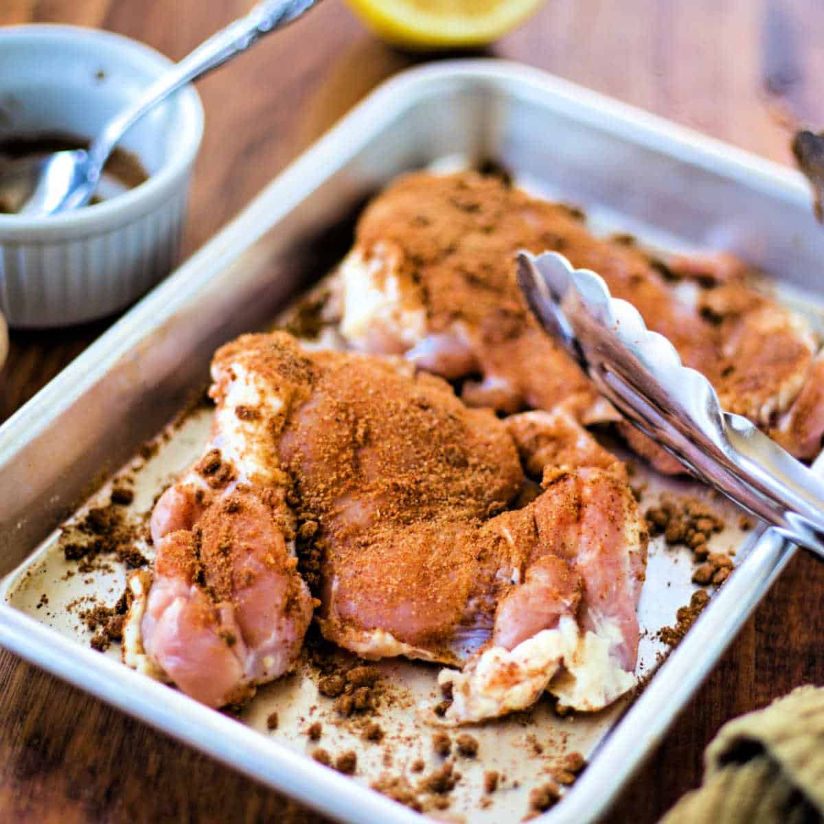 preparing shawarma spices on raw chicken