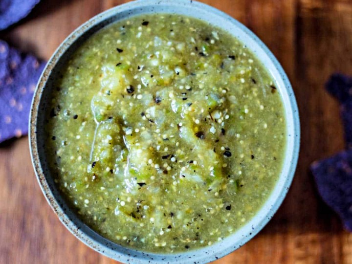 A bowl of food on a table, with Roasted Tomatillo Salsa