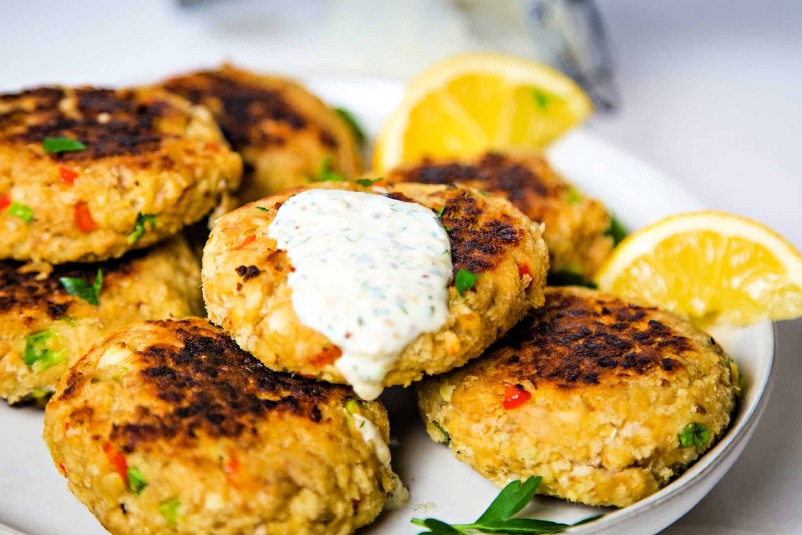 A plate of salmon patties with lemon slices