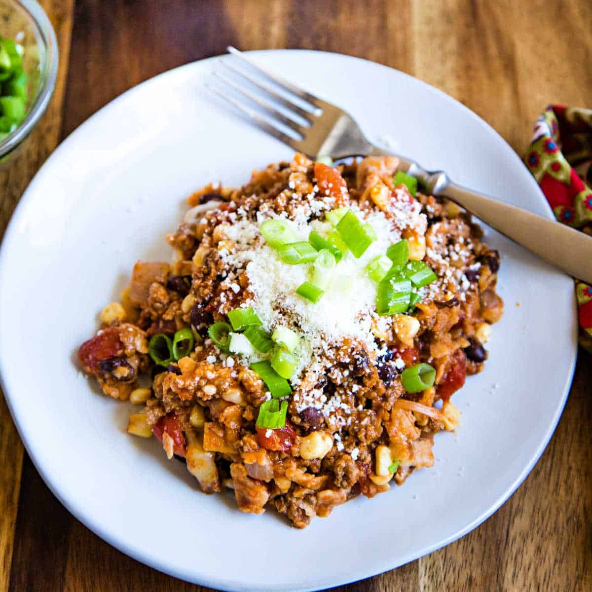 beef enchilada skillet topped with cojita cheese and green onions