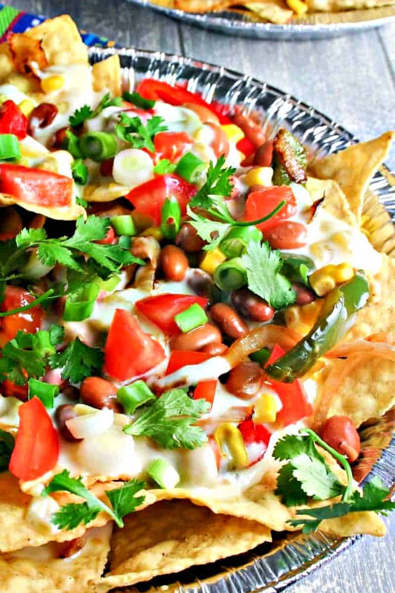 nachos with pinto beans, red bell peppers, and cheese sauce