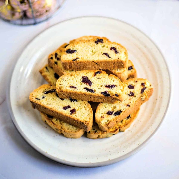 a stack of cherry biscotti on a white plate