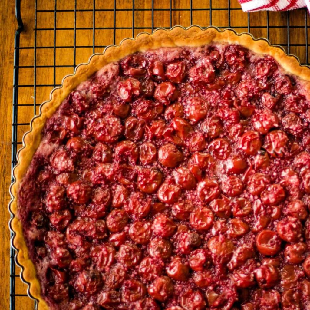 sour cherry tart on a wire rack