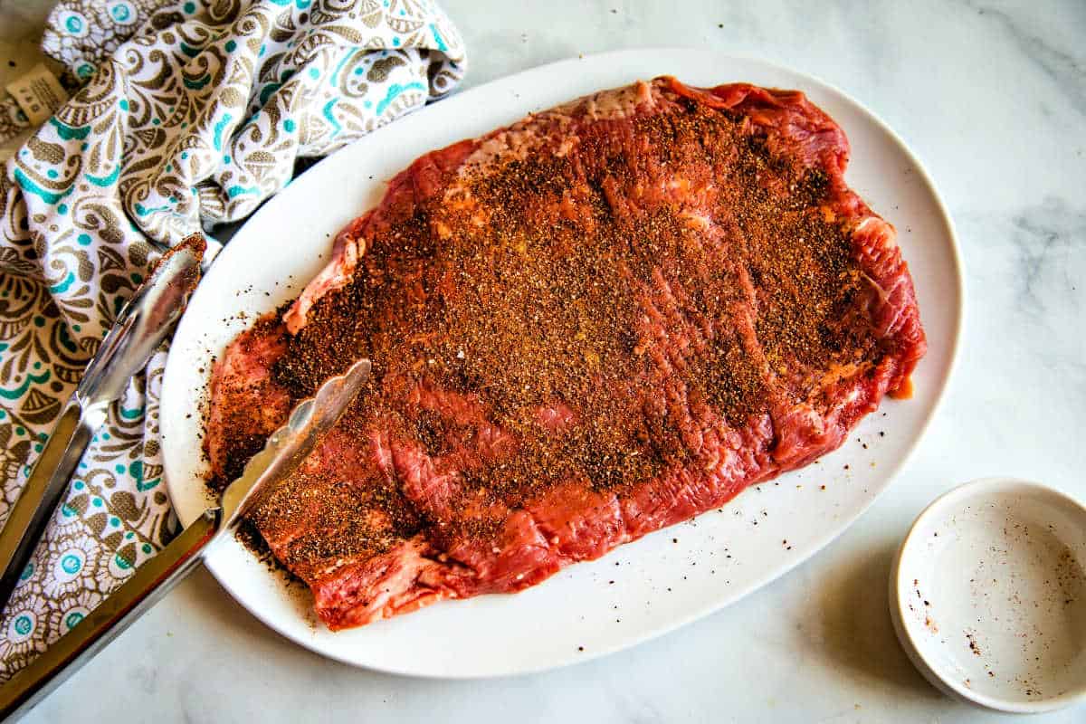 a flank steak on a platter with espresso dry rub