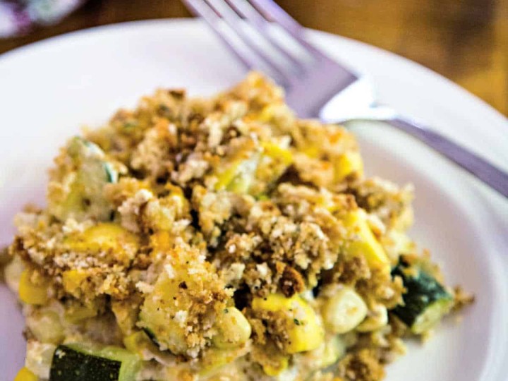 a serving of squash and zucchini casserole on a white plate