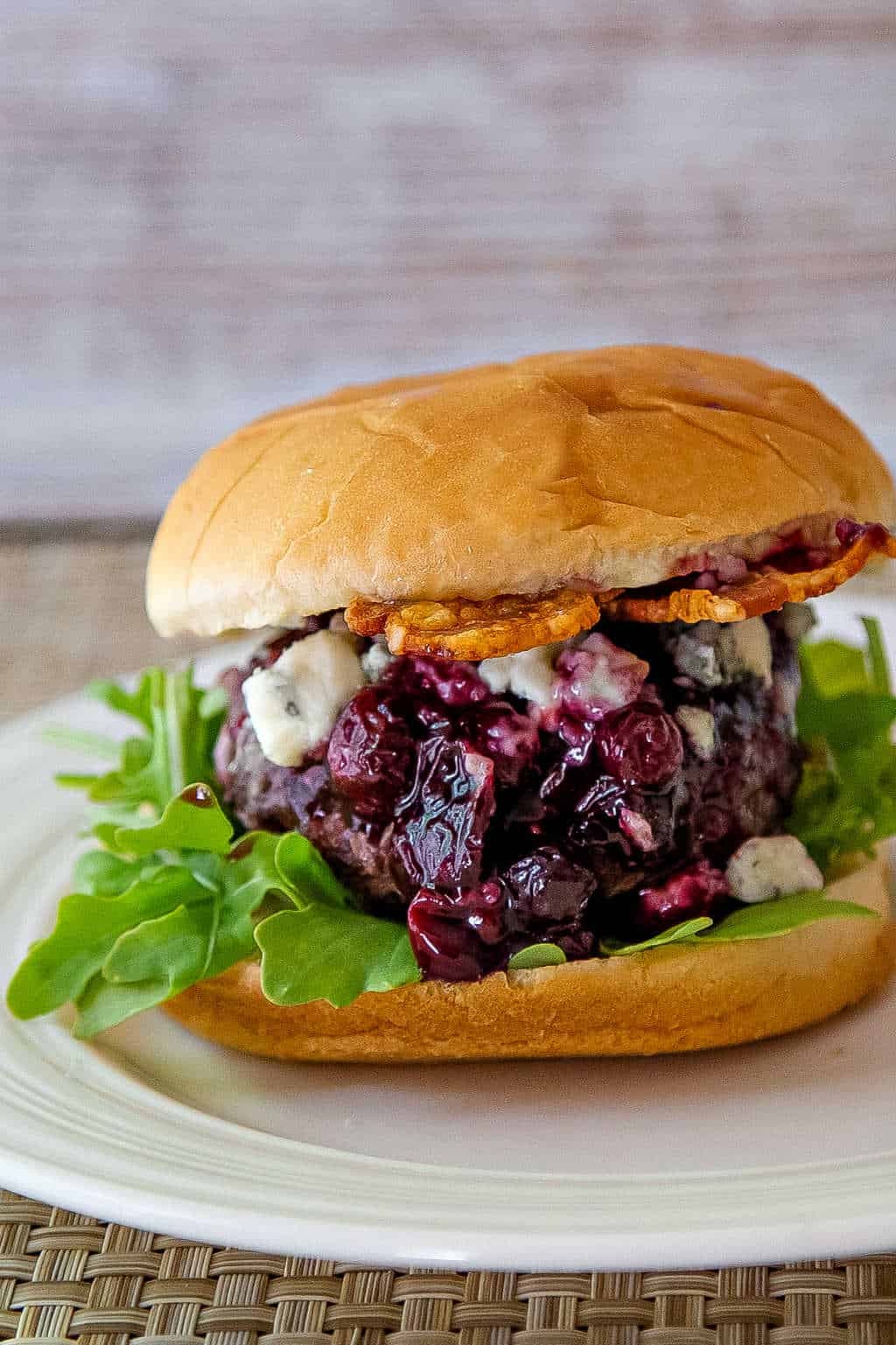 Blueberry Blue Cheese Bacon Burger on a white plate