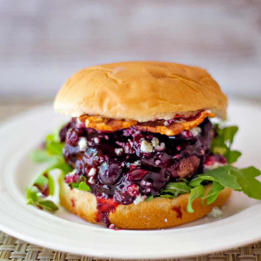 Blueberry Blue Cheese Bacon Burger on a white plate