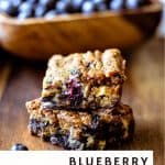 blueberry white chocolate chip cookie bars with a bowl of blueberries in the background
