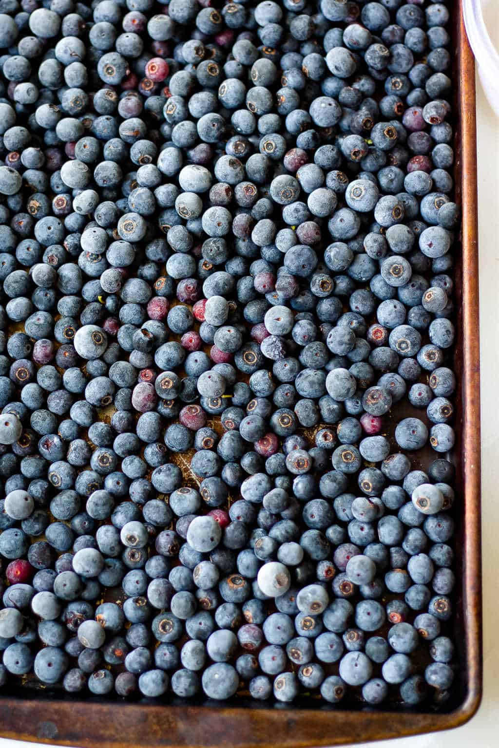 frozen blueberries on a baking sheet