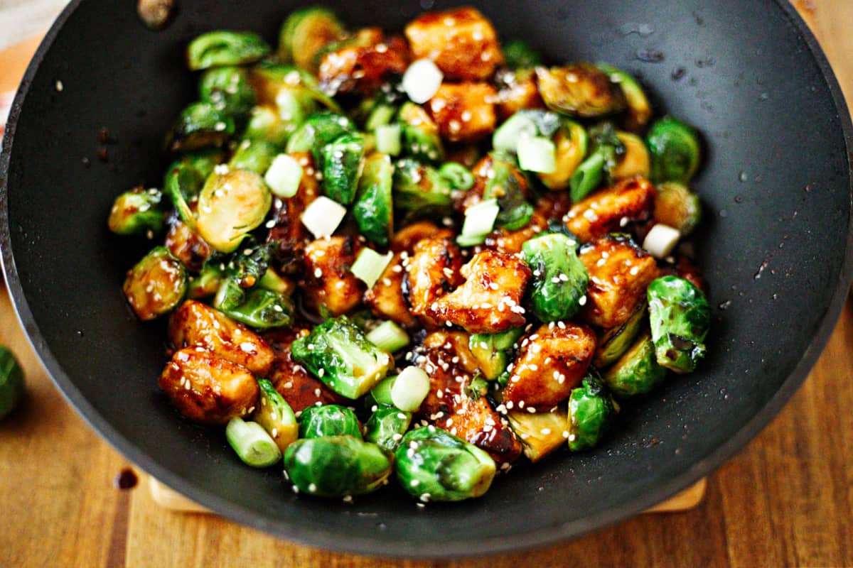 Sriracha Chicken and Brussels Sprouts Stir Fry in a wok