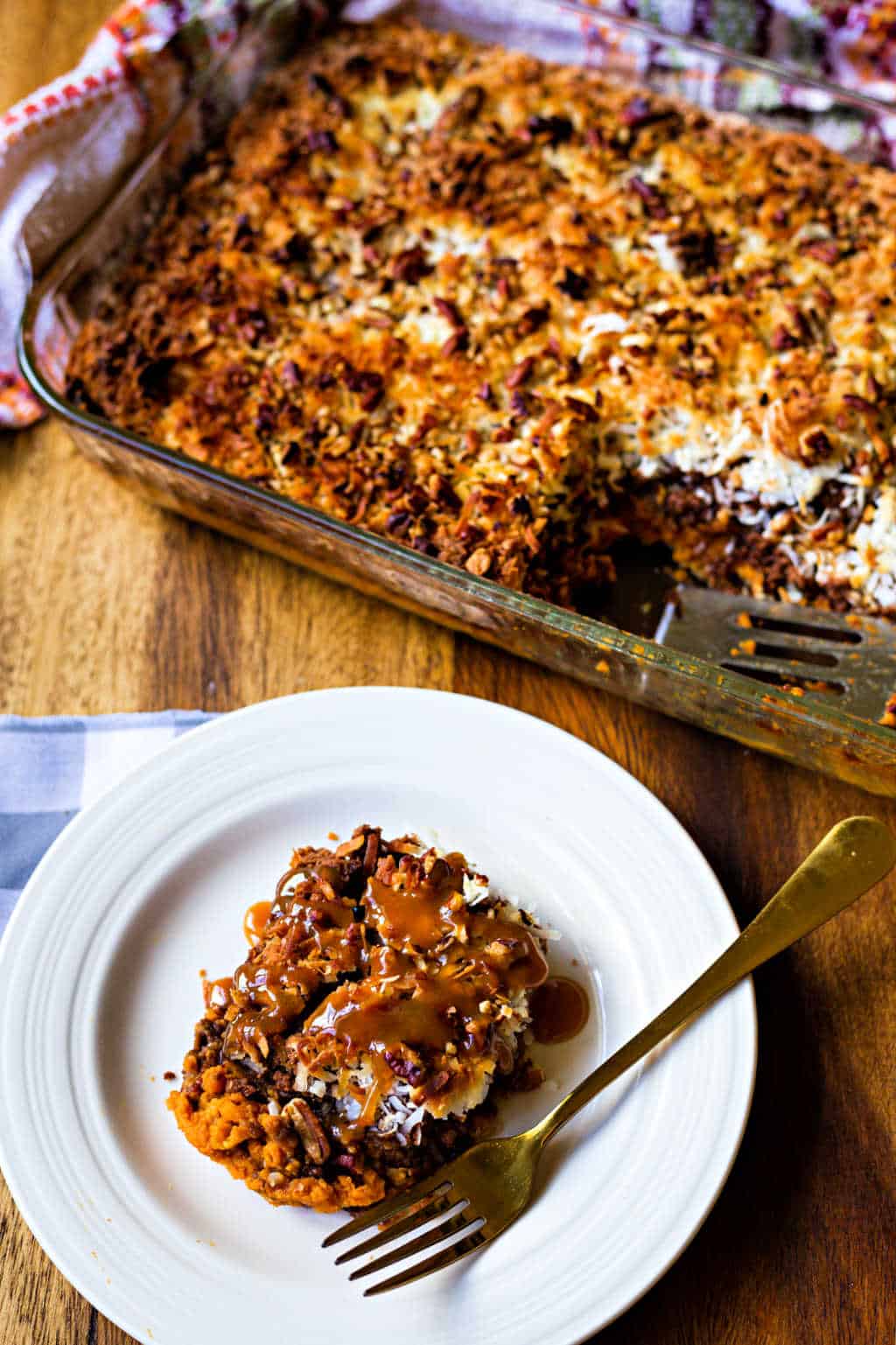 german chocolate pumpkin dump cake on a white plate with a gold fork