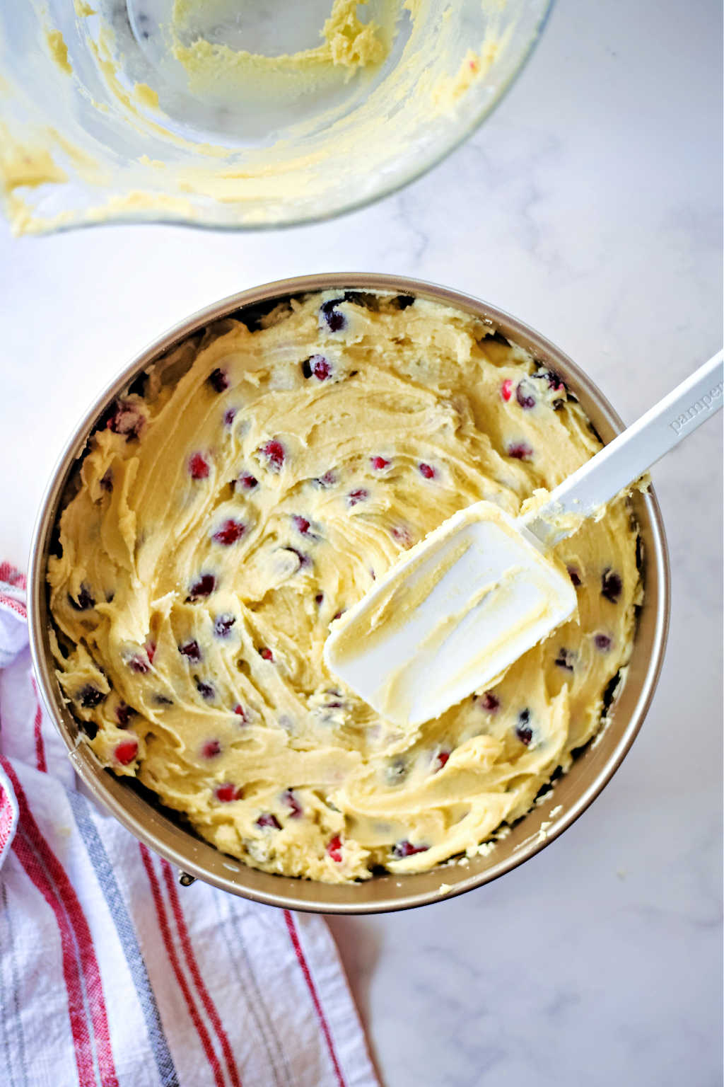 spreading cranberry cake batter in a springform pan
