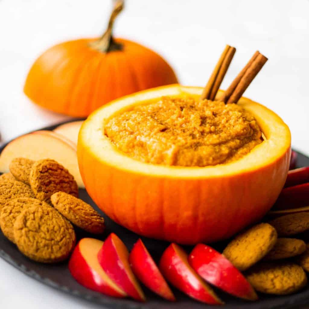 Pumpkin Mascarpone Dip on a black platter with ginger snaps and apple slices